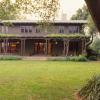 This is a view of back after restoration with restored eaves, roofing and pergola.