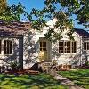 Hipped roofs were extended  into gable roofs, and the heirarchy of spaces became clear.  We added vertical corner and rake boards for crisp well defined edges.  Sash were replaced, and the  wrap-around corner window removed became 3 double hung windows.