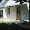 Six foot deep porches provide weather protection and shade for entries.  Window manufacturer (somehow!) made bottom sash with 9 lites instead of 6; they will be replaced.