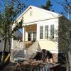 Photo taken during construction shows a third of the front porch enclosed, as if the house had been "remodeled" at some point to add a mudroom.  Hmmm.