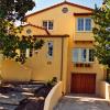 This is front view of house as completed.  Two new bedrooms are in front with playroom, master suite and bath behind.  Walls were restuccoed in this delicious mango color.  Main floor entry, living room and bedroom were left untouched by renovation.