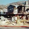 We moved house to site four miles away in Altadena, CA.  It had to be cut into three sections.  Photo shows it soon after restoration began.  New foundation was built, and the building lowered onto it.