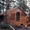 In a similar view during construction we see red cedar shingles, decking and trim being installed.