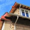 Close-up shows new tongue and groove roof sheathing, exposed framing and half-round gutters-- all period-appropriate details for a 1910 house.  New windows are dual-glazed, but match existing details.