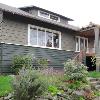 View prior to renovation shows original gable roof with a tiny shed dormer facing view of Portage Bay.  Pergola was roofed and decks extended in earlier remodels.